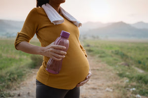 pregnant woman drinking water