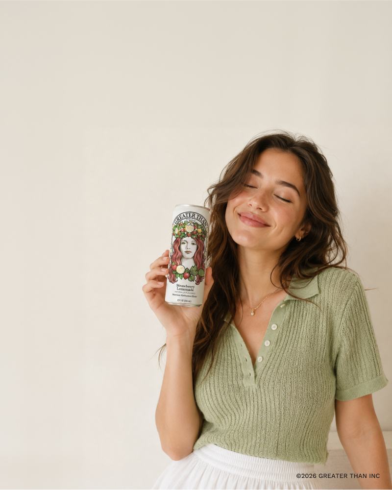 Holding a can of GREATER THAN